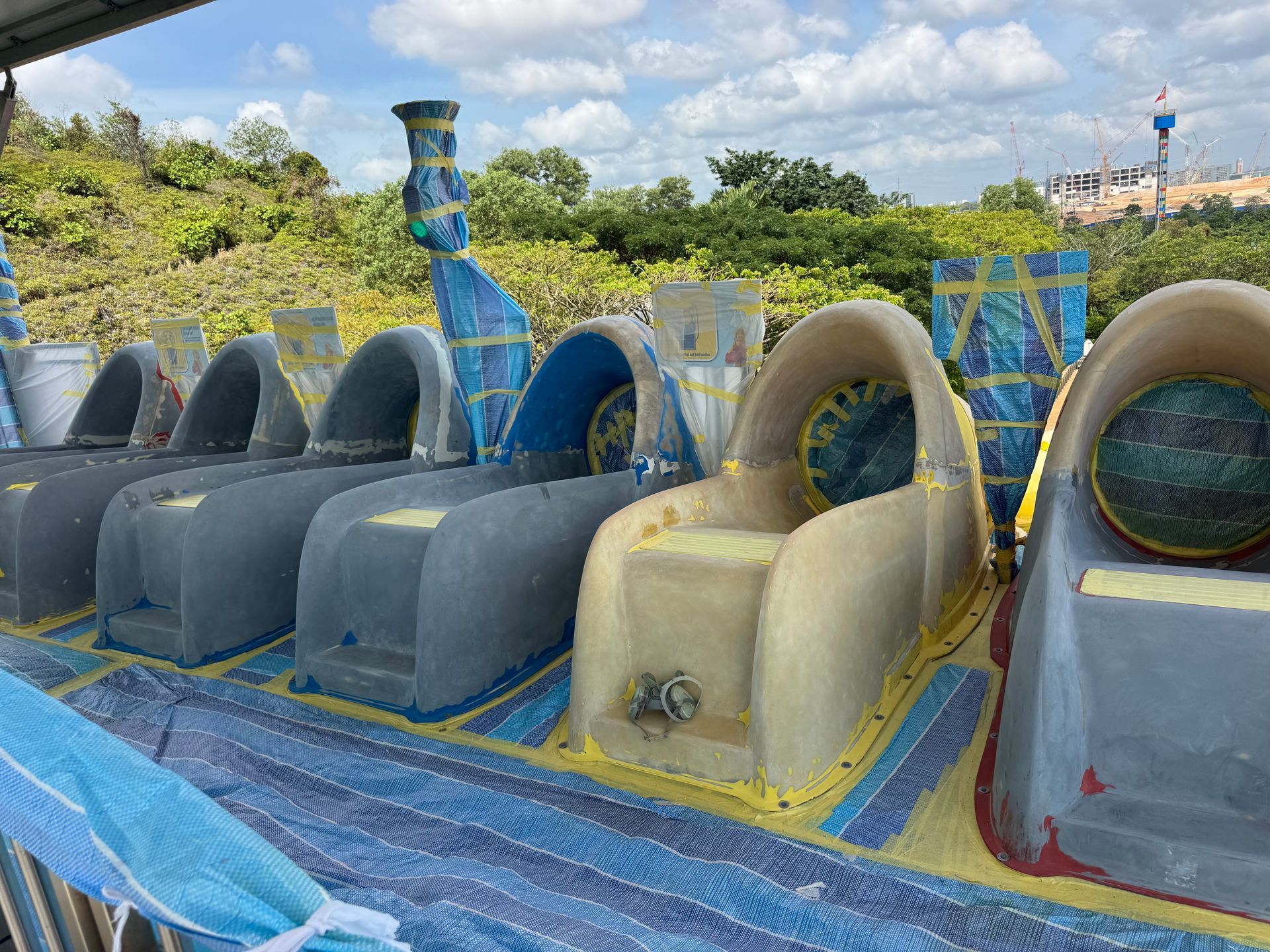 Waterslide launch chutes stripped to bare fiberglass and masked for gelcoat application at Legoland Malaysia