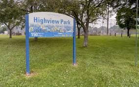 A blue and white park sign reading 