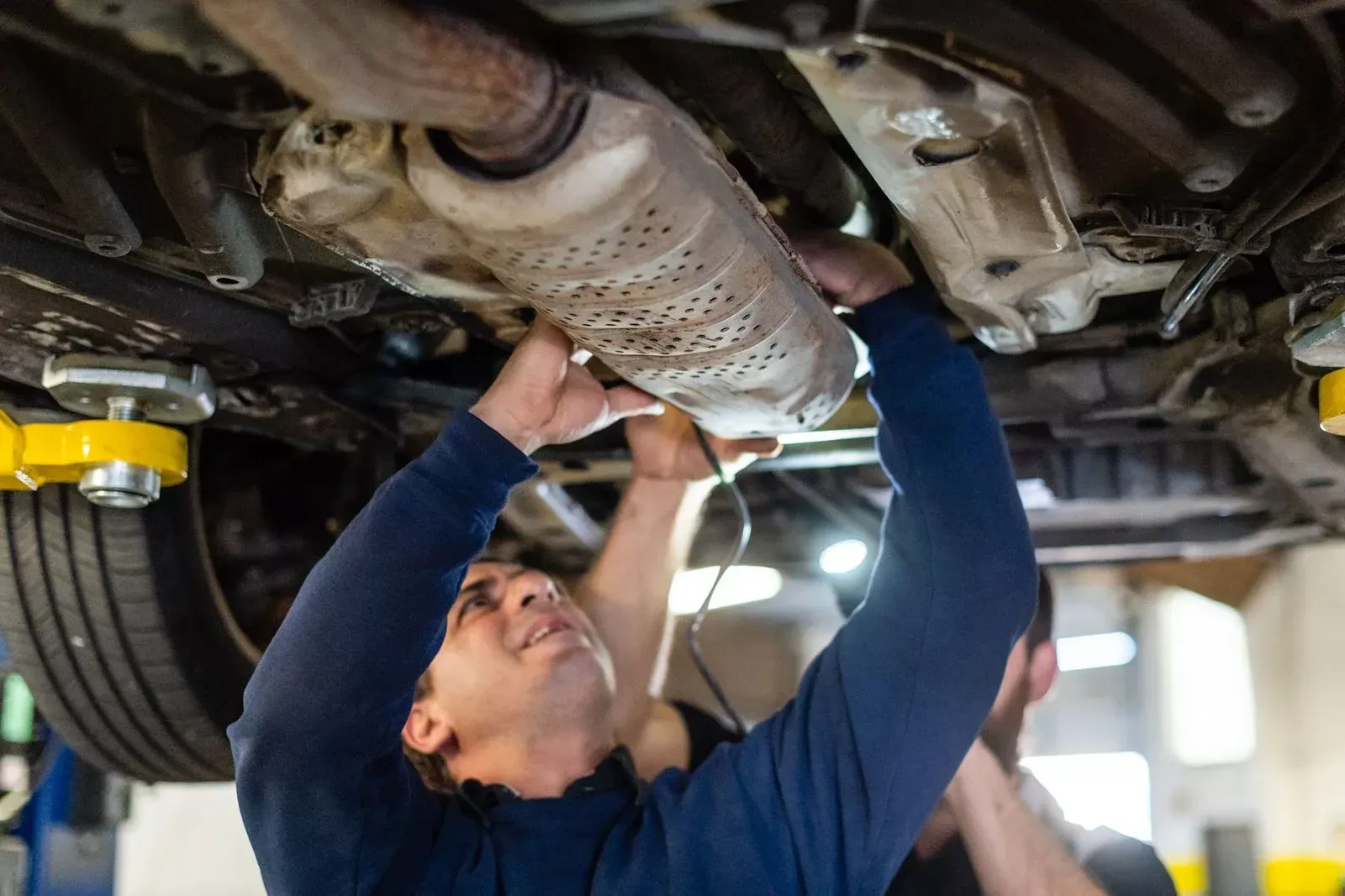 A technician at our repair shop working on a vehicle | Texas Automotive Performance