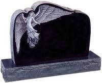 Black granite tombstone with a carved bird and draped cloth on the upper left corner