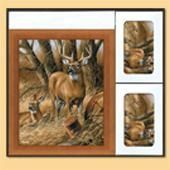 Framed deer artwork with two small matching prints on a beige background