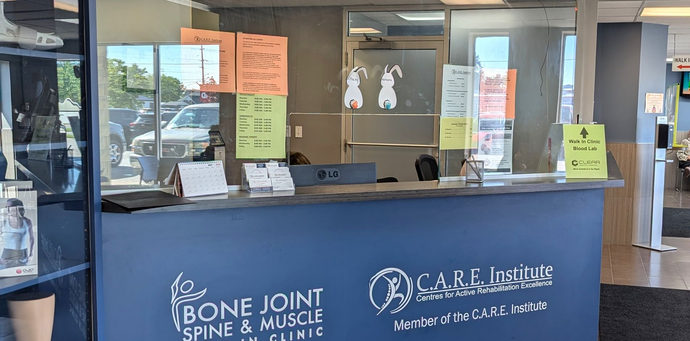 A nurse is stretching a patient 's leg with a purple rubber band.