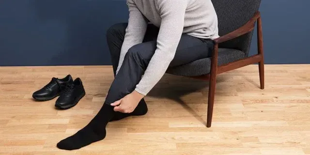 A woman is getting her wrist examined by a doctor.