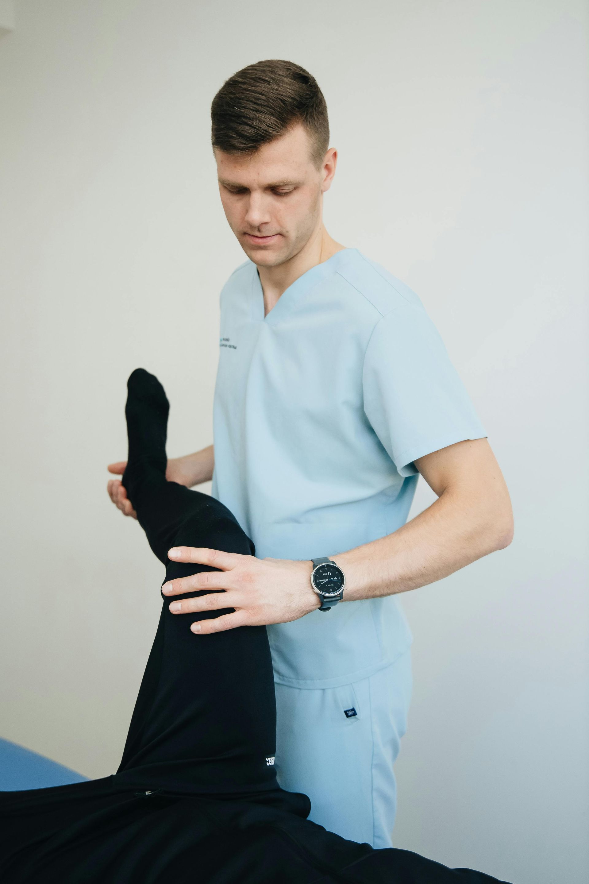 A woman is getting her wrist examined by a doctor.