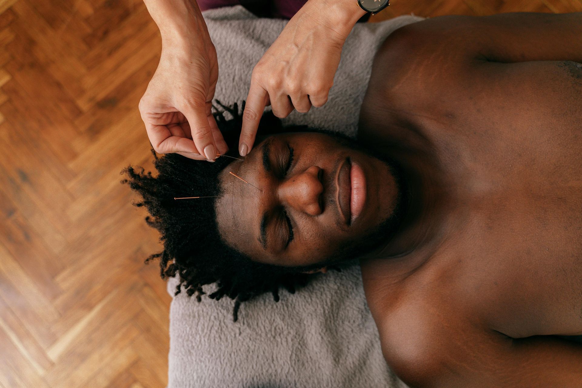 A woman is getting her wrist examined by a doctor.