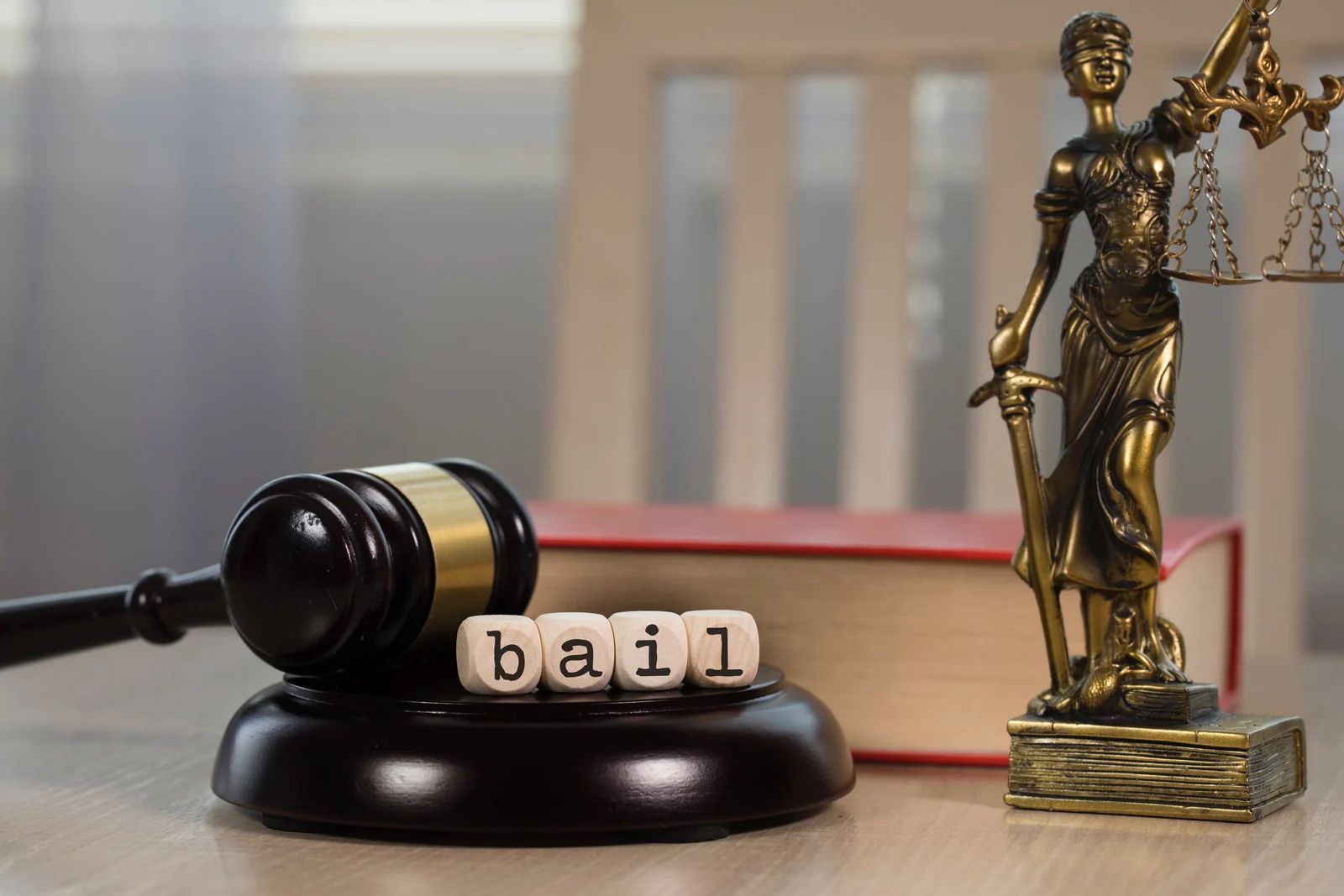 A judge’s gavel rests on a wooden base with the word