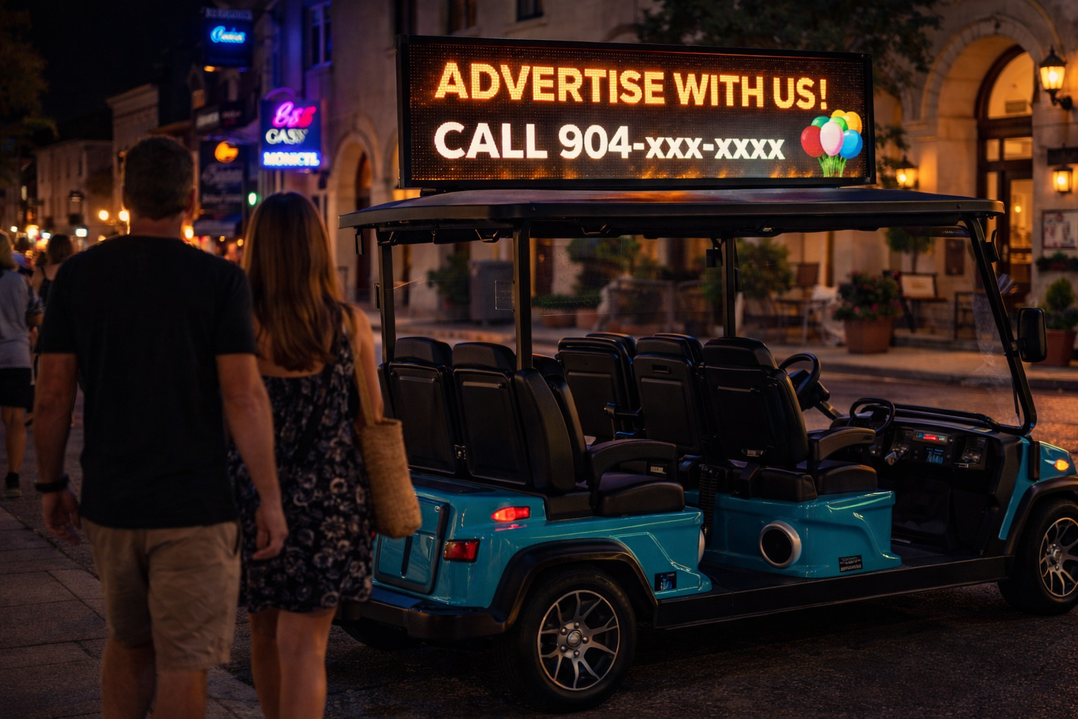 A group of people ride in a blue golf cart, smiling, in front of a two-story house with a balcony and decorations.