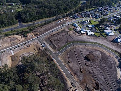 An aerial view of a construction site in a residential area.