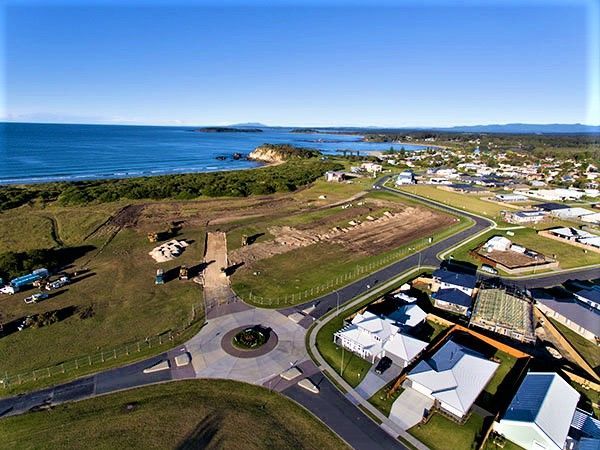 An aerial view of a residential area next to the ocean.