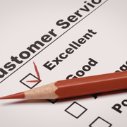 Red pen marking “Excellent” on a customer service survey form