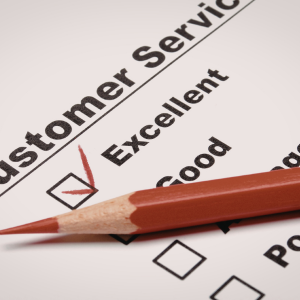Red pen marking “Excellent” on a customer service survey form
