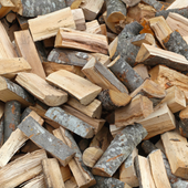 Pile of split firewood logs in light and dark brown tones, stacked closely together.