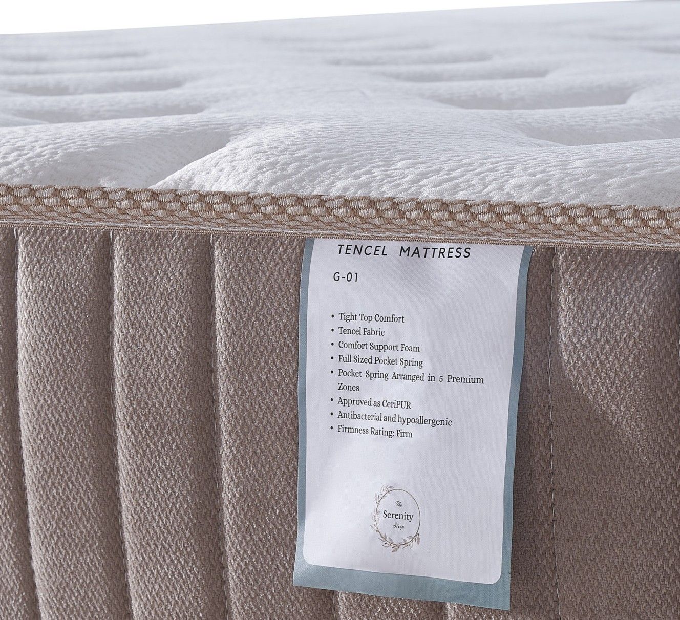 Quilted white mattress with gray patterned sides and subtle blue and tan accents on the top surface