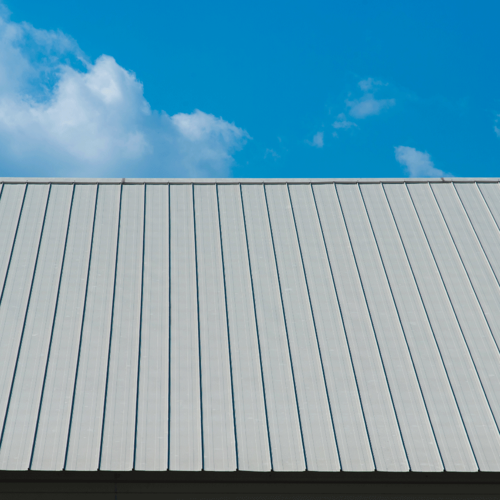 Metal roof under a blue sky with a few white clouds