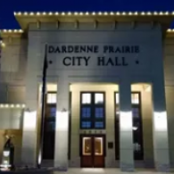 Dardenne Prairie City Hall at night, with illuminated columns and entrance.