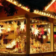 Festive shop window glowing with warm lights, star decorations, and holiday gift displays