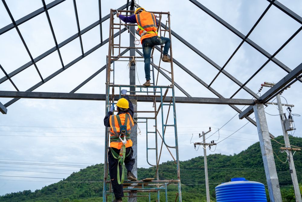 Construction Workers on a Metal Scaffold, Building a Roof Frame — Rohr Electrical in Wellington, NSW