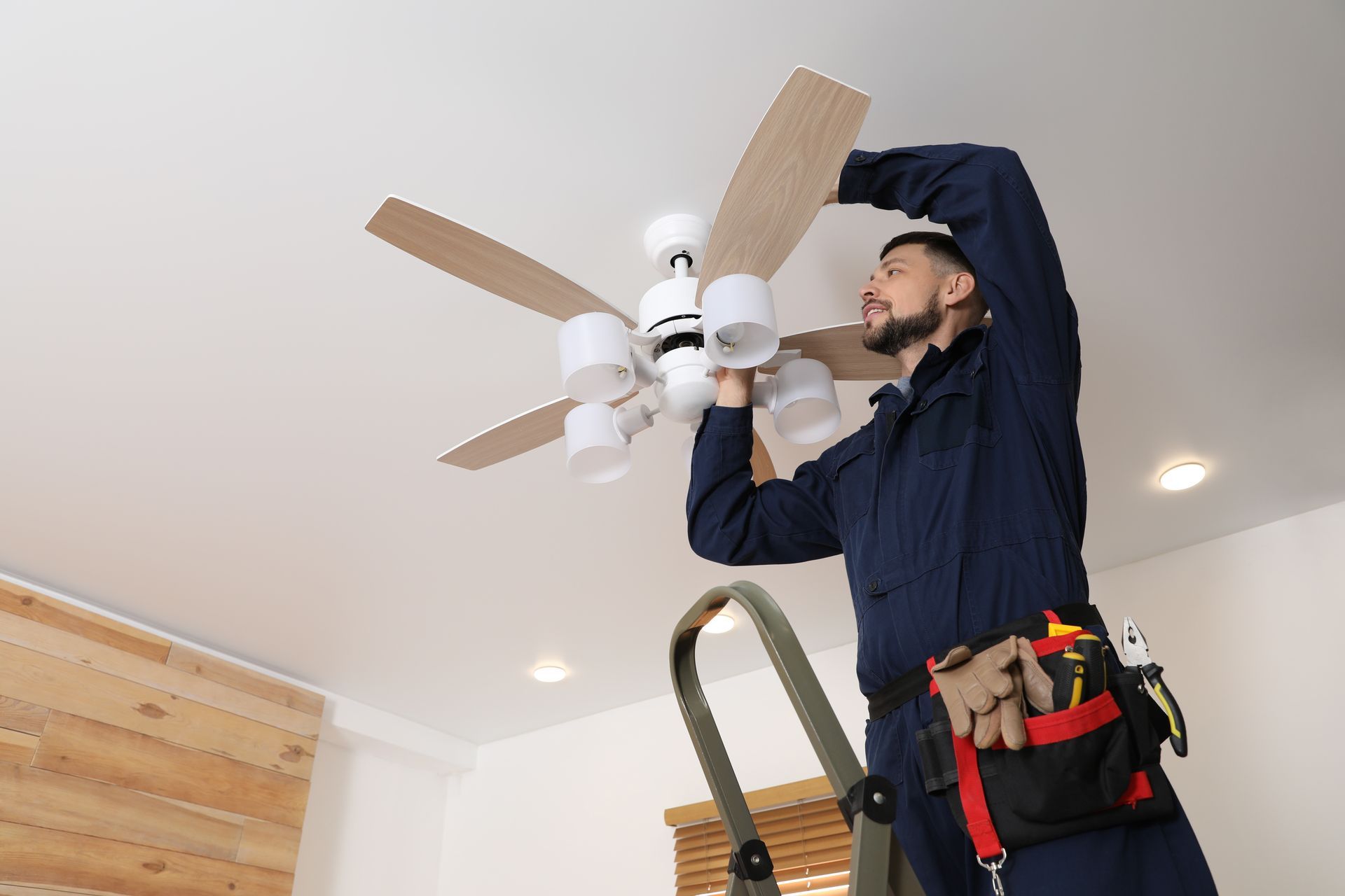 Electrician Installing a Ceiling Fan — Rohr Electrical in Dubbo, NSW