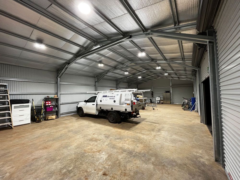 Sheds With A Lot Of Lights Installed Inside The Shed With Pick Up Truck — Rohr Electrical In Dubbo NSW