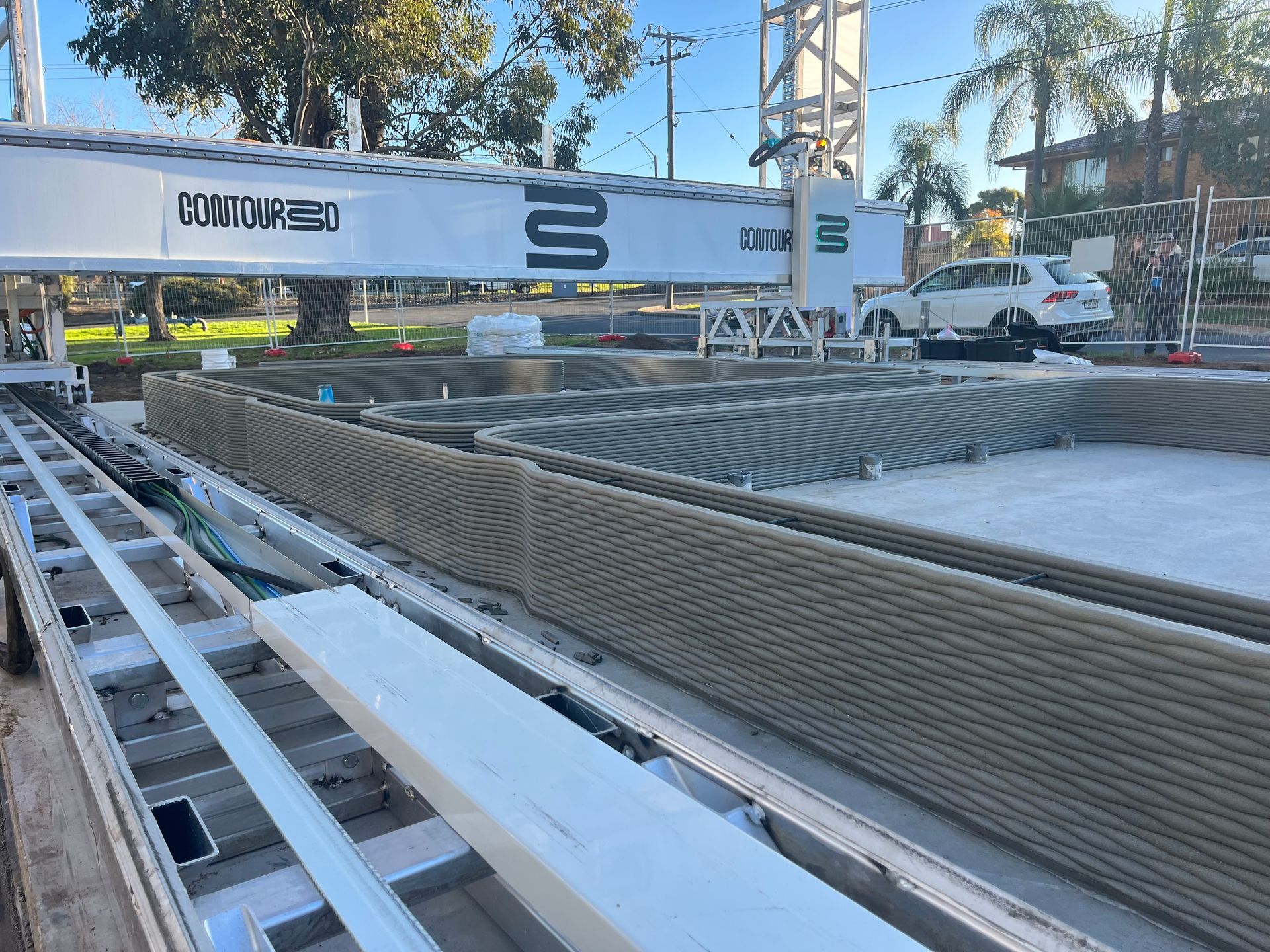 A Large 3d Printer Building a Gray Concrete Structure Outdoors — Rohr Electrical in Dubbo, NSW