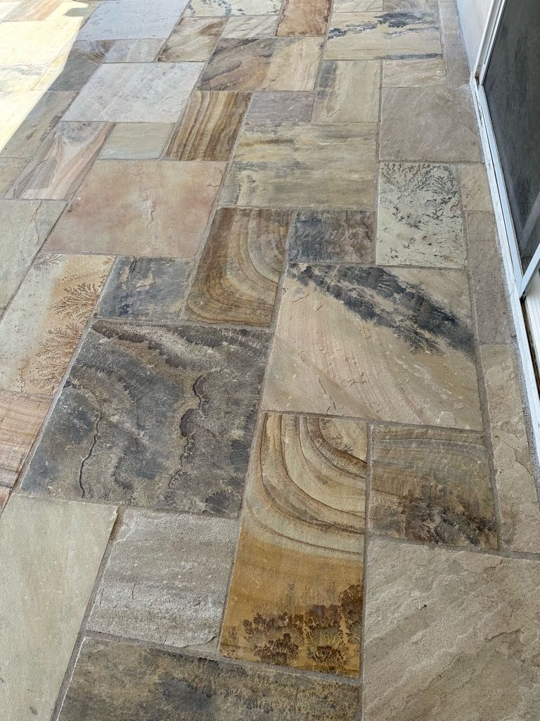 A close up of a tiled floor on a sidewalk.