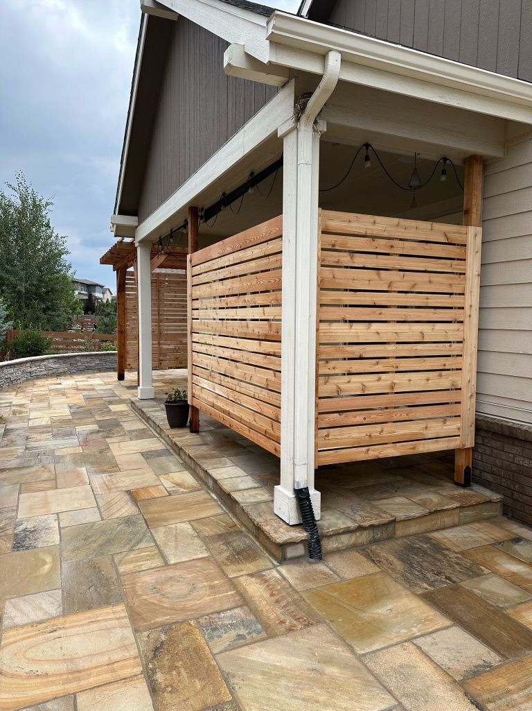There is a wooden fence in front of a house.
