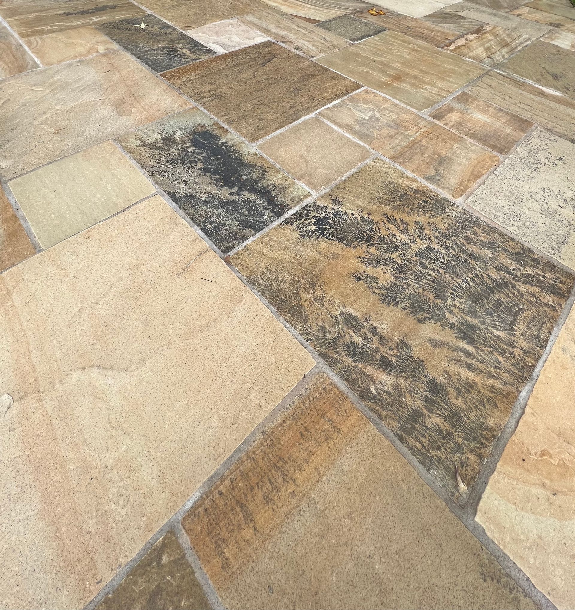 A close up of a tiled floor with a diagonal pattern