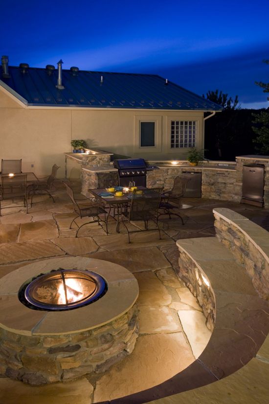 There is a fire pit in the middle of the patio.