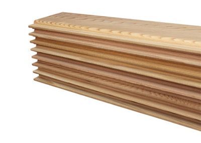 Stack of light wood boards with grooved edges, shown in a close-up on a white background