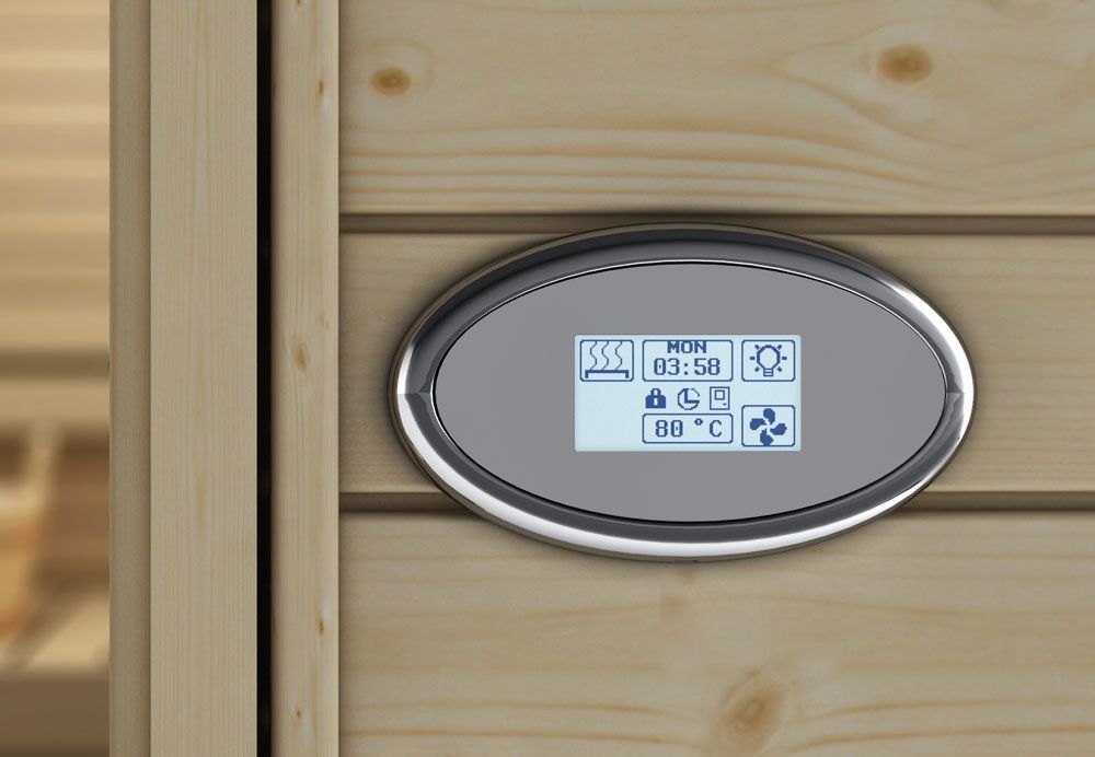 Oval digital thermostat mounted on a wooden wall, with a small blue display and buttons.