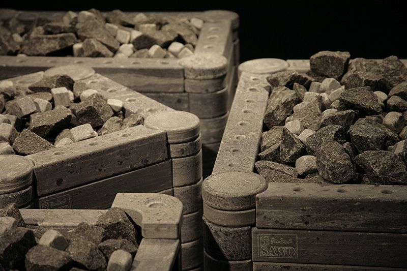 Three wooden crates filled with charcoal briquettes on a dark background