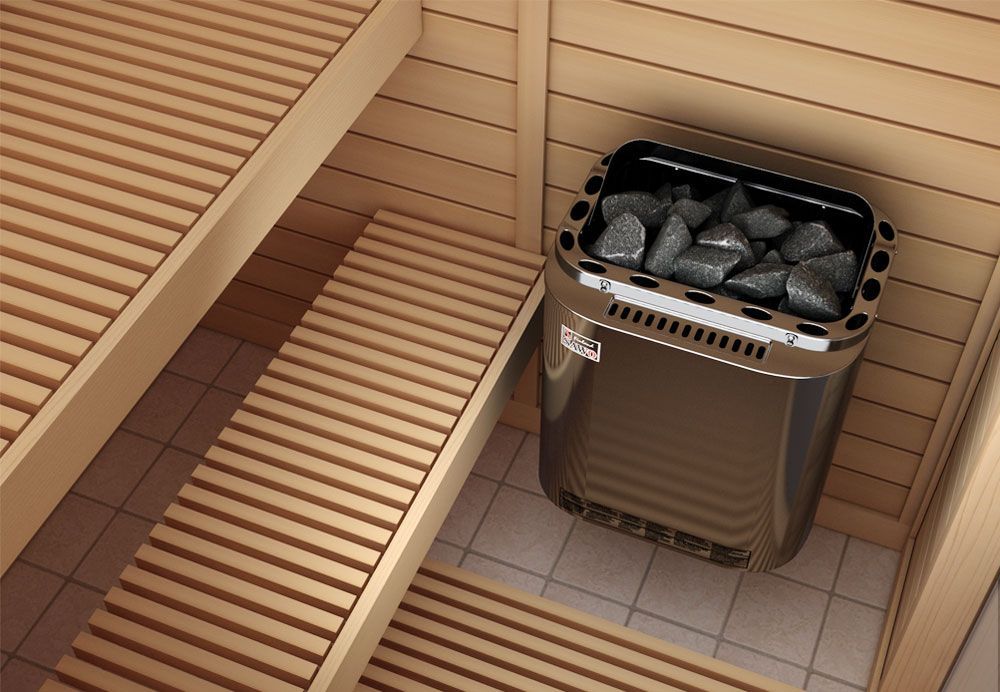 Sauna interior with wooden benches and a metal stove filled with rocks
