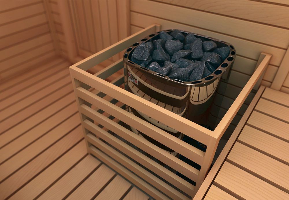 Wooden sauna bench with a metal bucket of steaming hot stones in a warm, slatted room