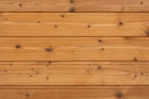 Horizontal wooden plank wall with warm brown grain and knots