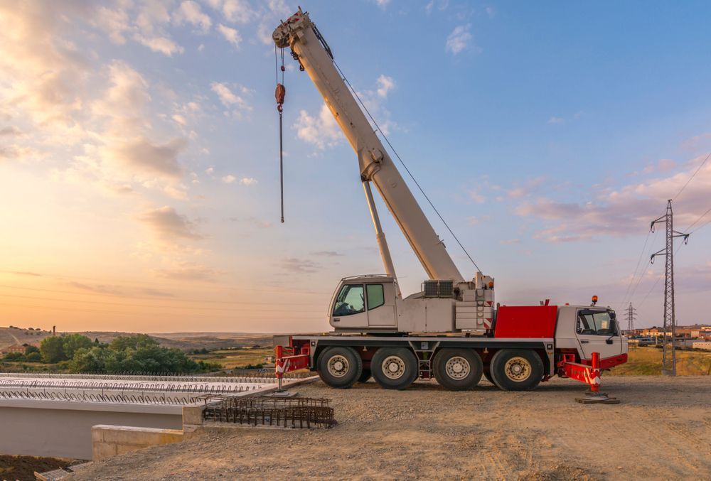 A Large Crane is Sitting on Top of a Truck on a Construction Site — Alexander Crane Tippers in Goulburn, NSW