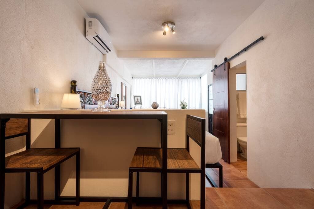 There is a table and chairs in the middle of the room.