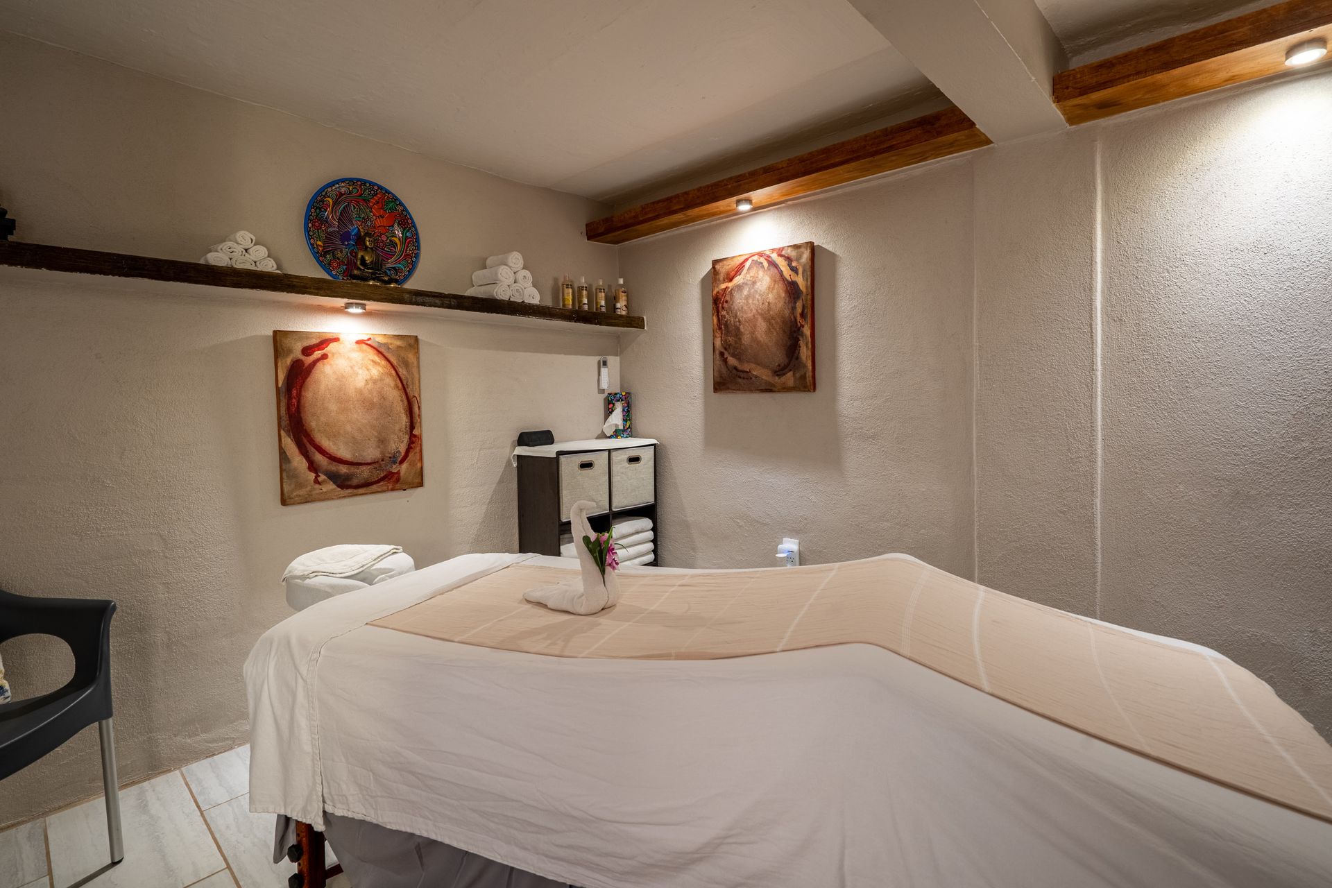 There is a massage table in the middle of the room.