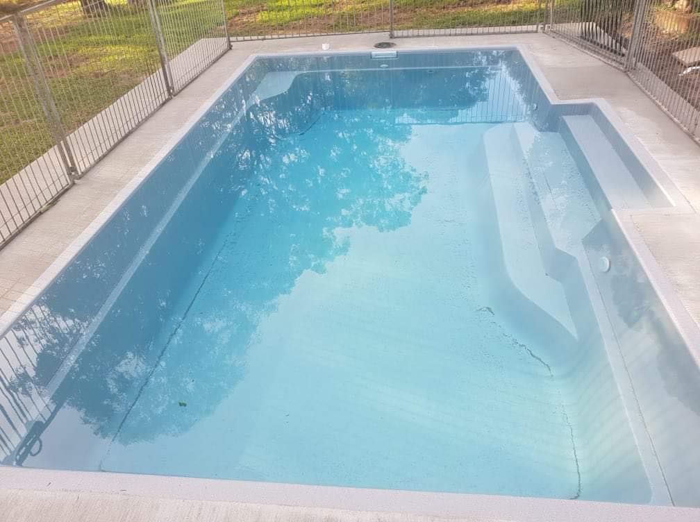 Rectangular Swimming Pool With Steps, Filled With Light Blue Water — Clearwater Pools Hallidays Point in Harrington, NSW