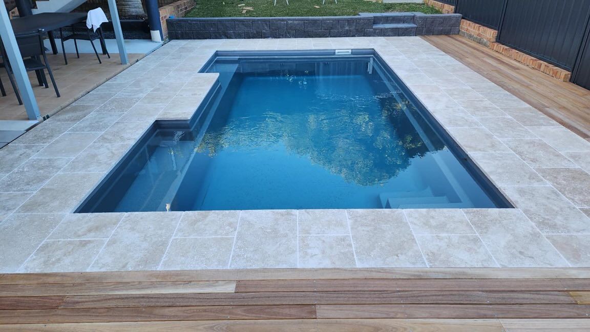 Pool With Light Tile Surround, Set in Deck, Water Reflecting Trees — Clearwater Pools Hallidays Point in Hallidays Point, NSW