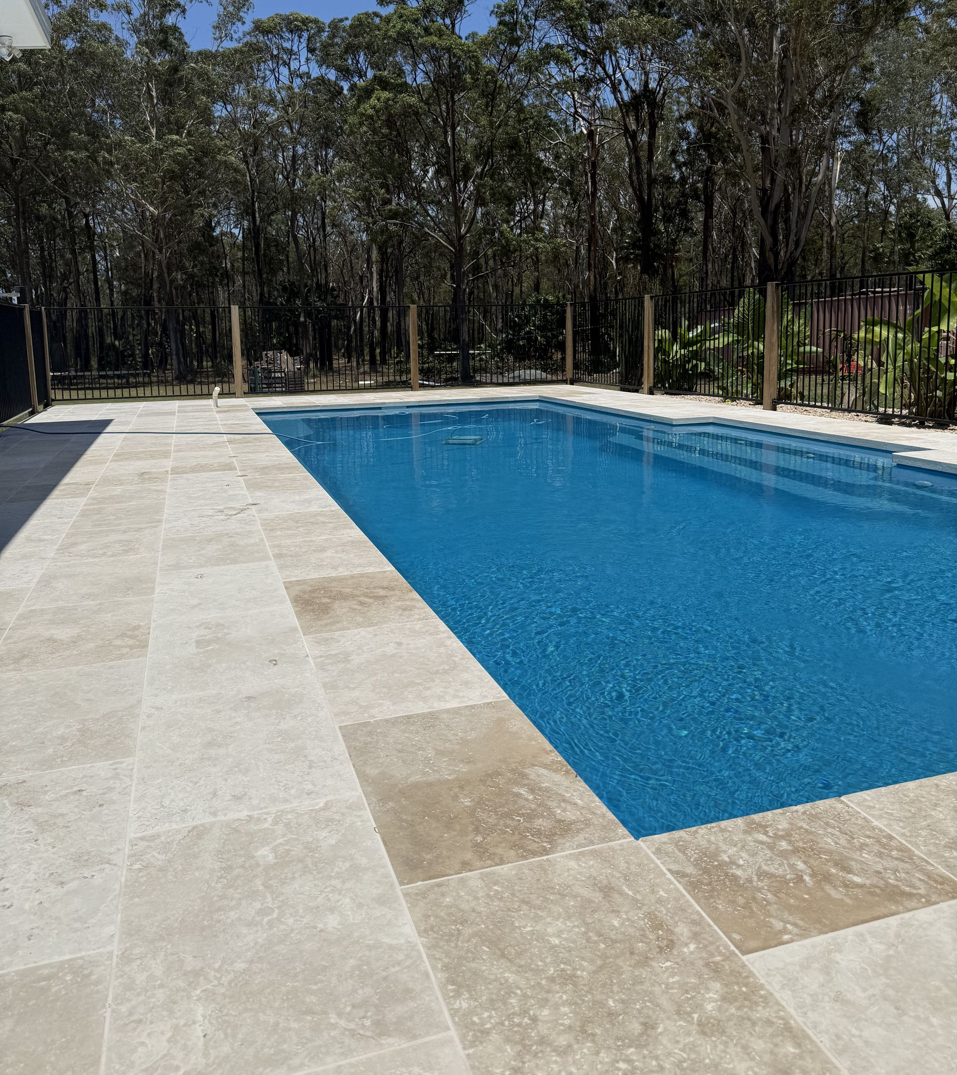 Swimming Pool With Water, Surrounded by Paving. Trees — Clearwater Pools Hallidays Point in Hallidays Point, NSW