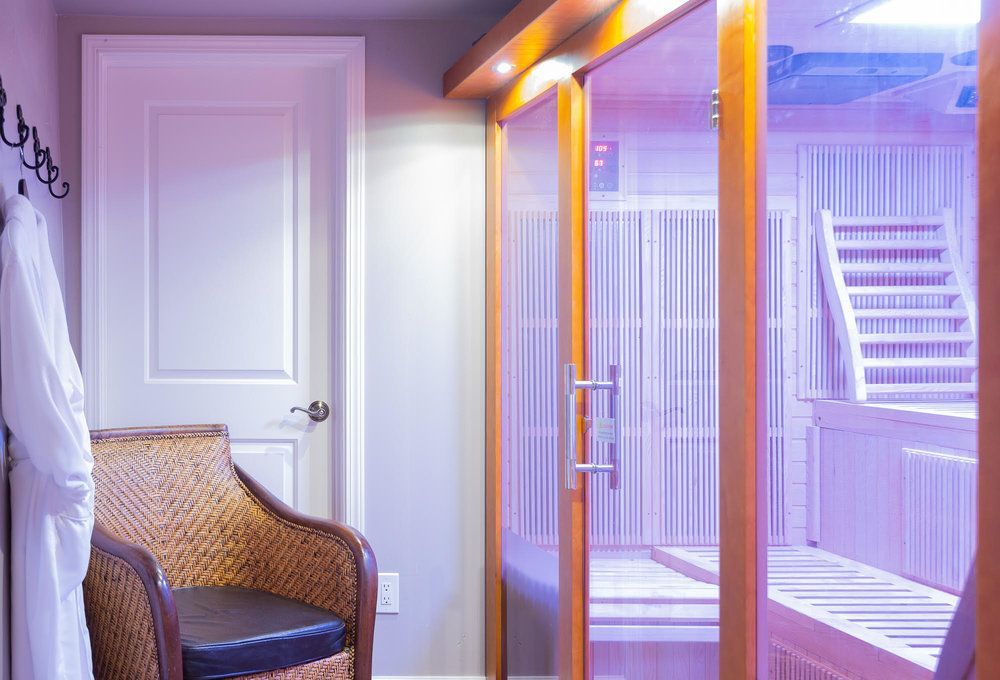 A chair is sitting in a room next to a sauna.