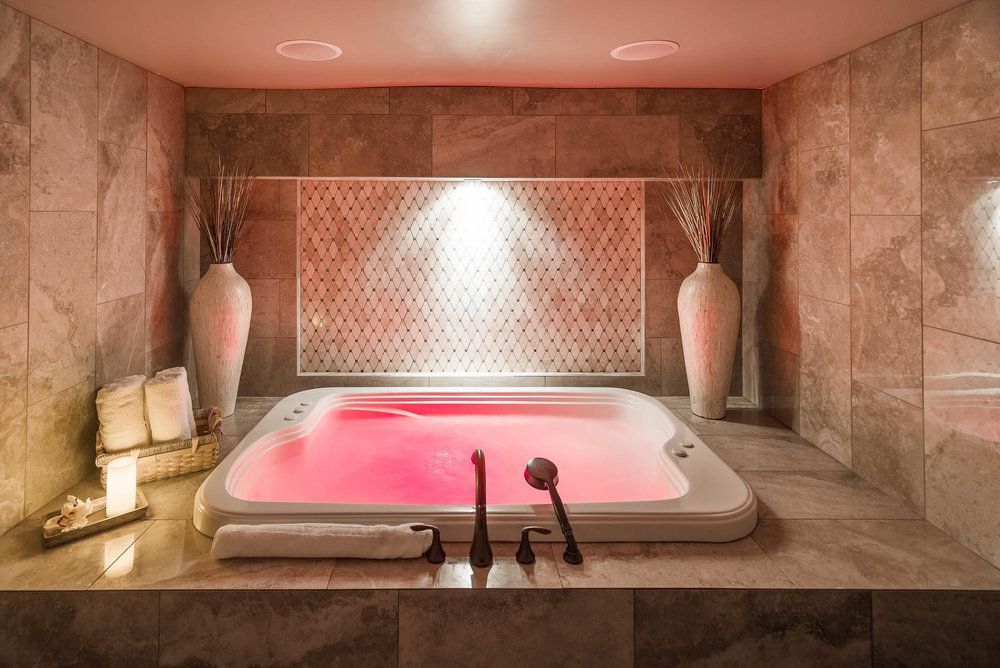 There is a large jacuzzi tub in the middle of the bathroom.