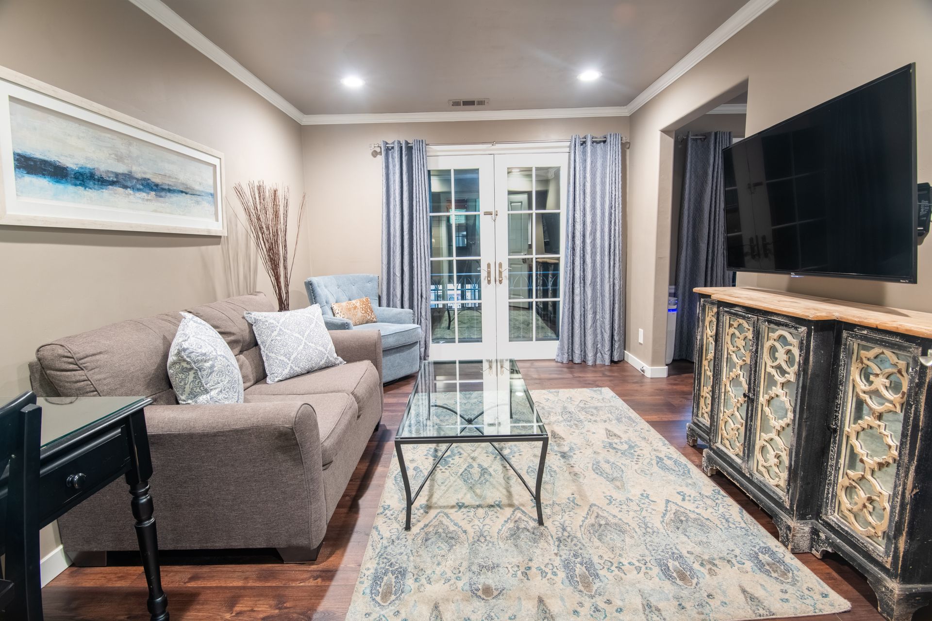 A living room with a couch , coffee table , and television.