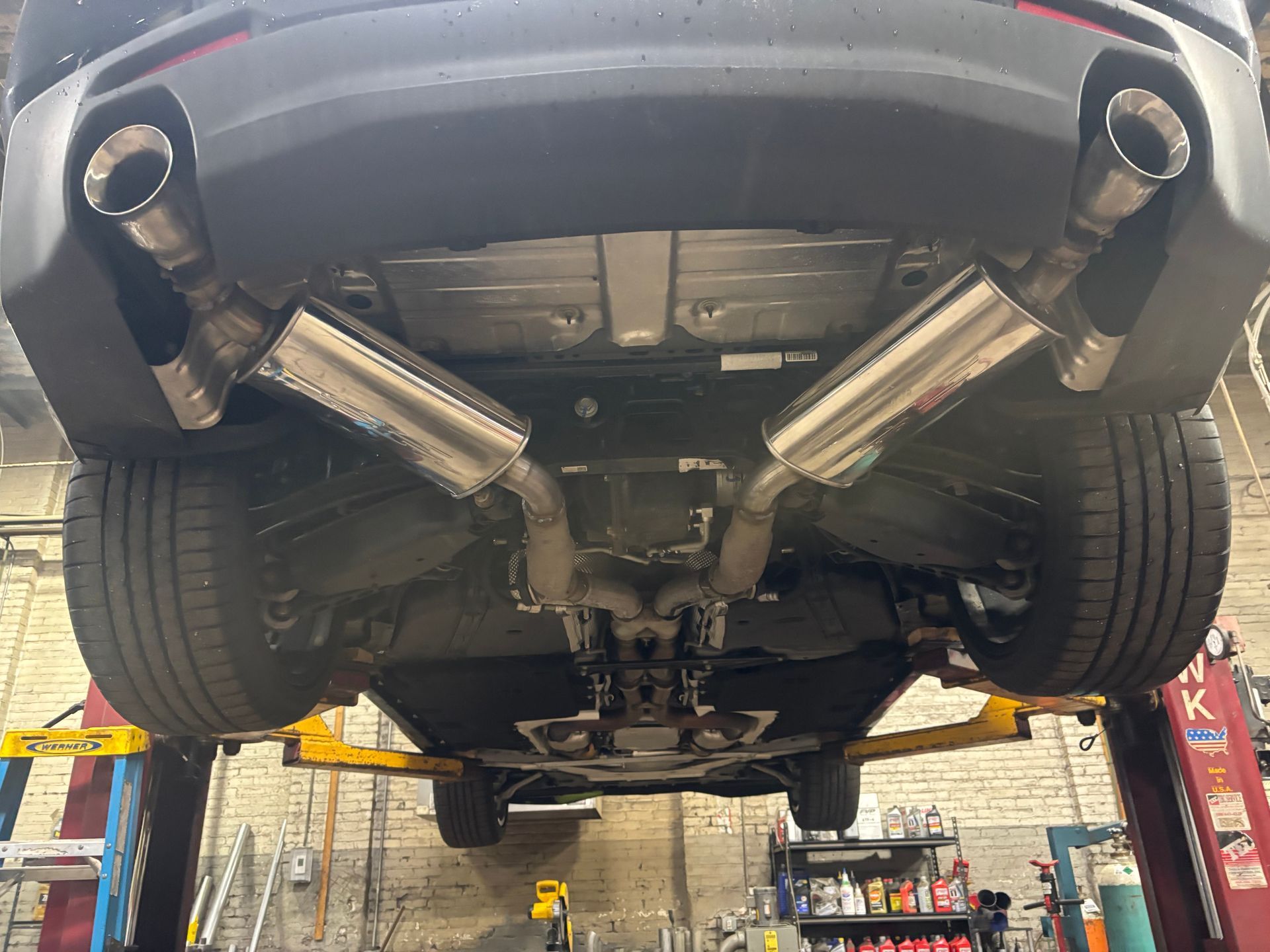 Professional exhaust service in Worcester, MA Car exhaust repair and installation at Lou’s Custom Exhaust in Worcester, MA – undercar view of vehicle on lift
