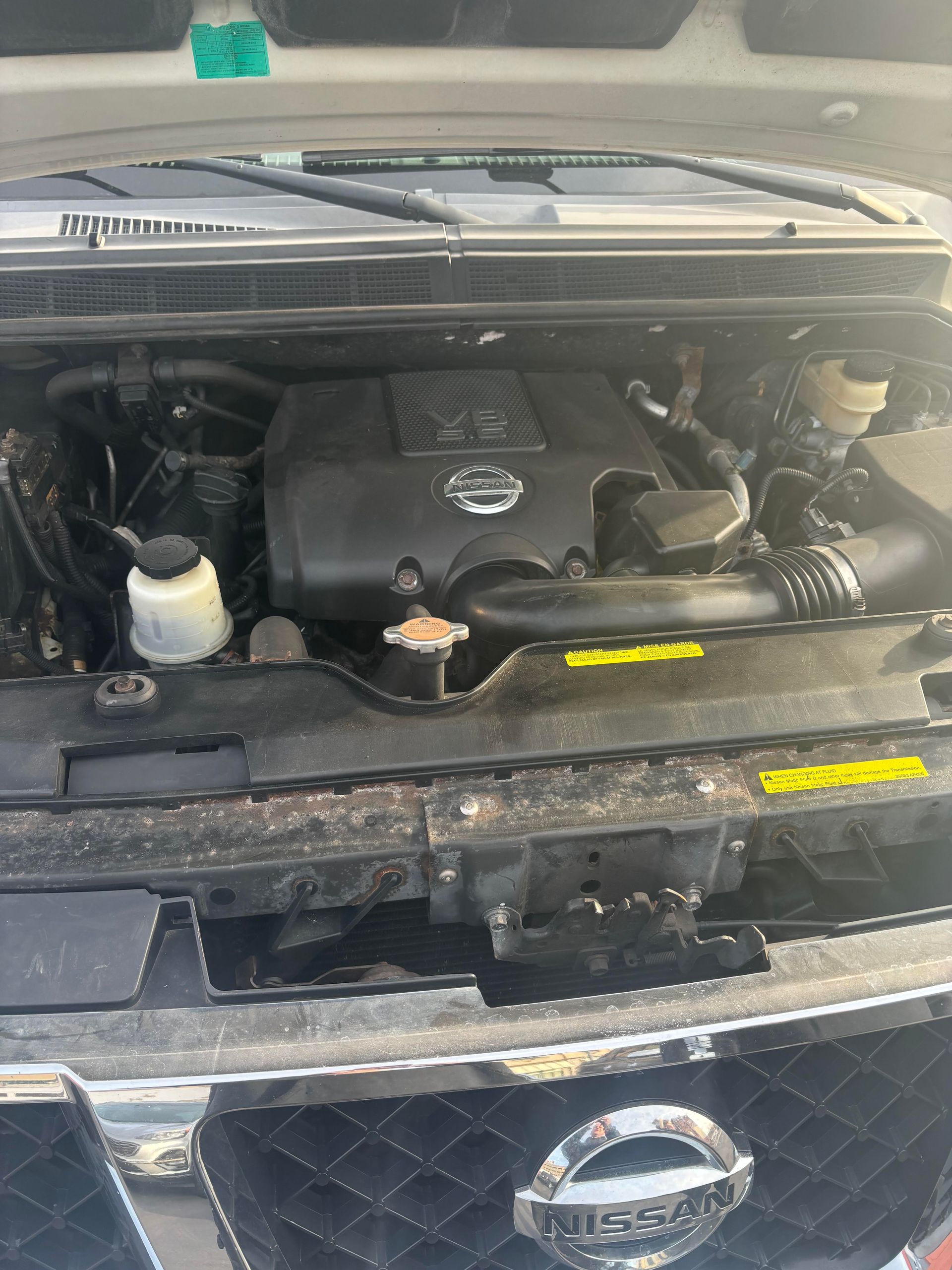 Engine compartment of Nissan Armada SUV for sale at Lou’s Custom Exhaust Worcester MA