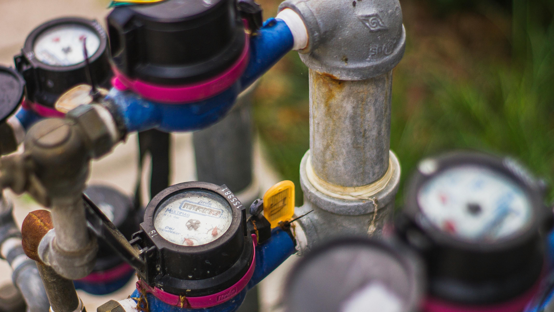 Water meters and pipes with black and pink accents.