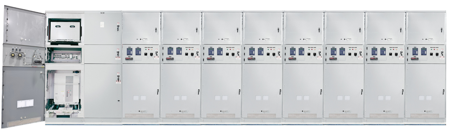 Row of gray electrical control cabinets with gauges and switches in an industrial room