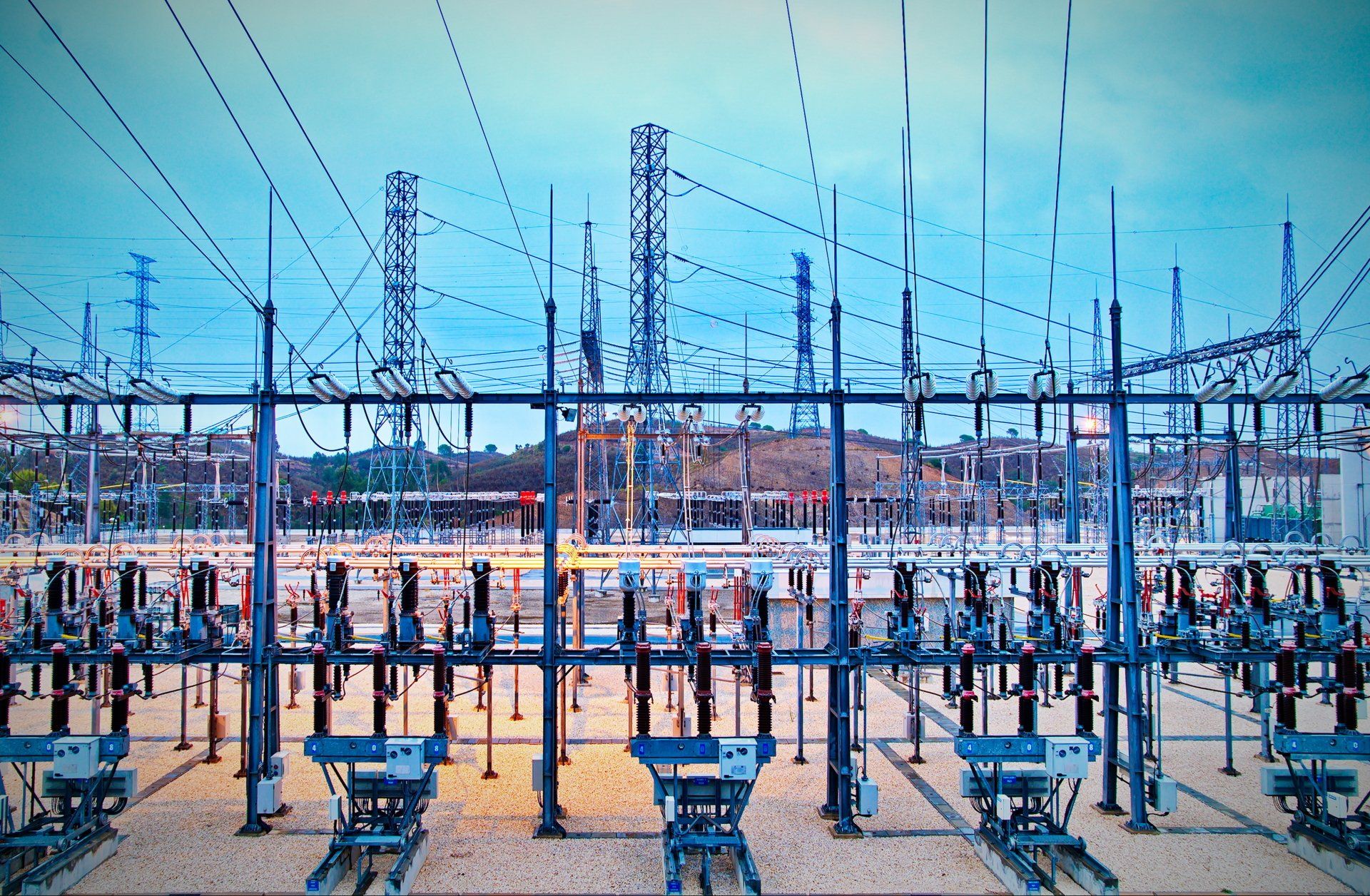 A large electrical substation with a lot of power lines.