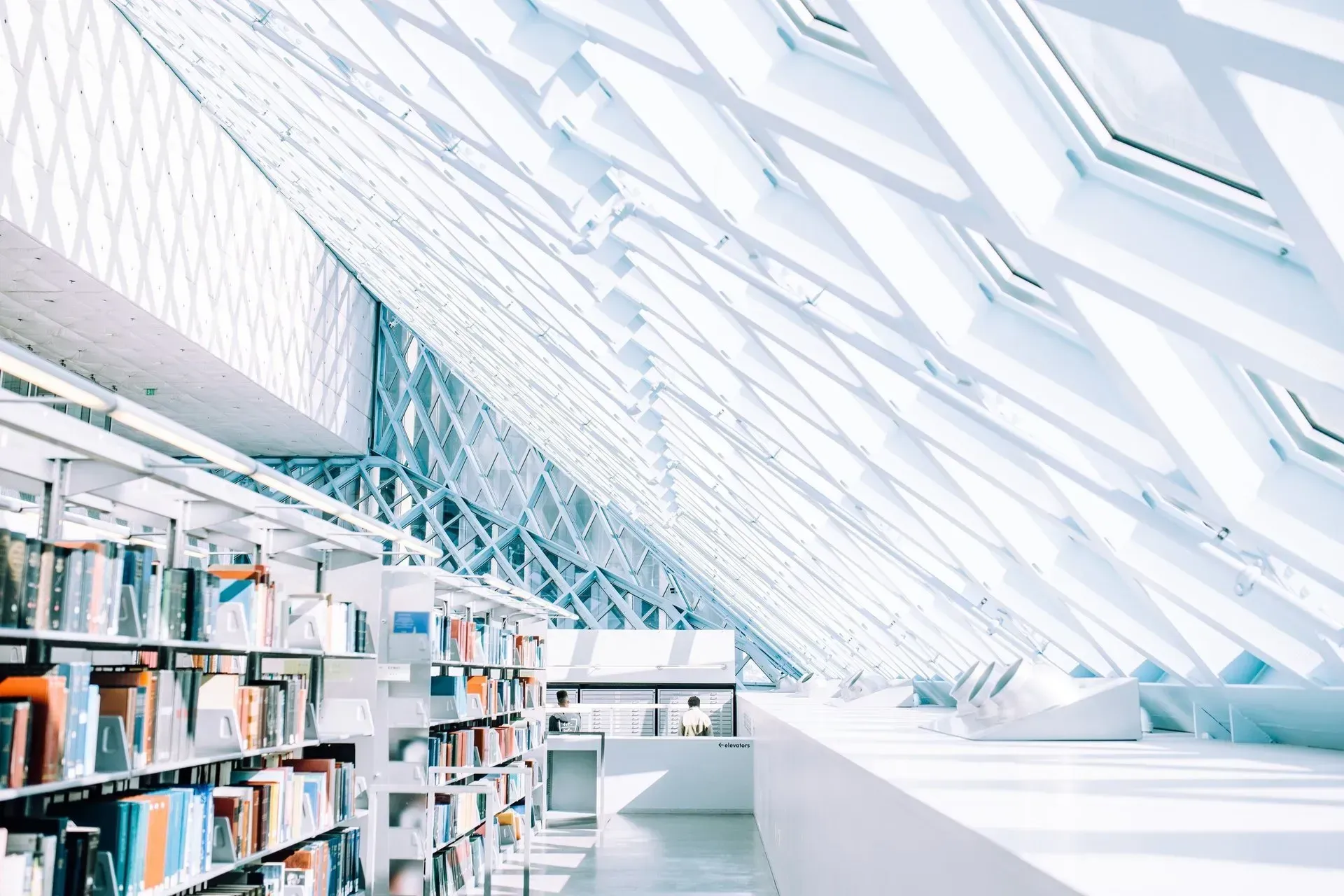 Bright modern library with bookshelves and a skylit glass ceiling