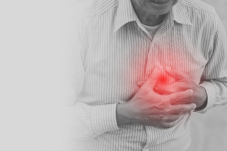Person clutching chest with red glow indicating heart pain or discomfort